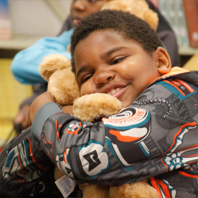 Boy hugging stuffed animal