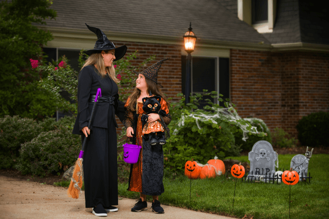 adult and child in witch costumes