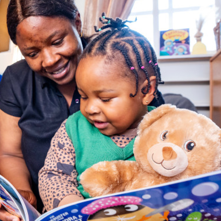 Build-A-Bear woman and girl reading a book
