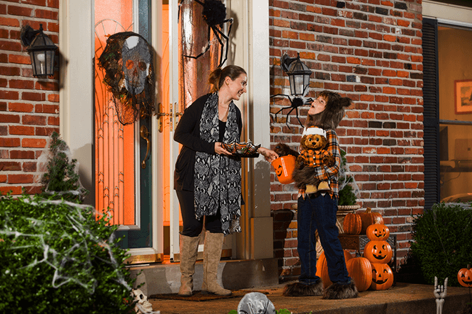 child receiving candy at halloween