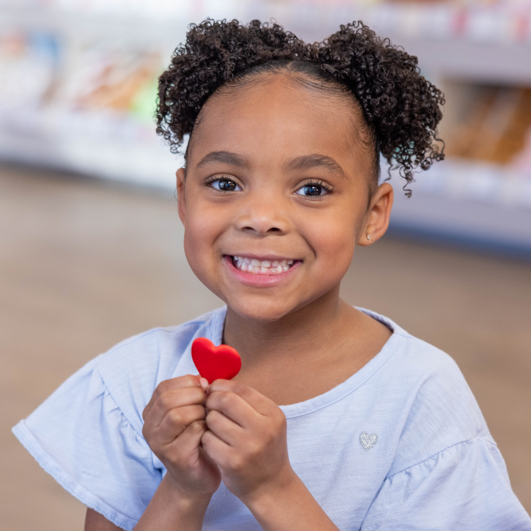 Build-A-Bear girl holding a heart